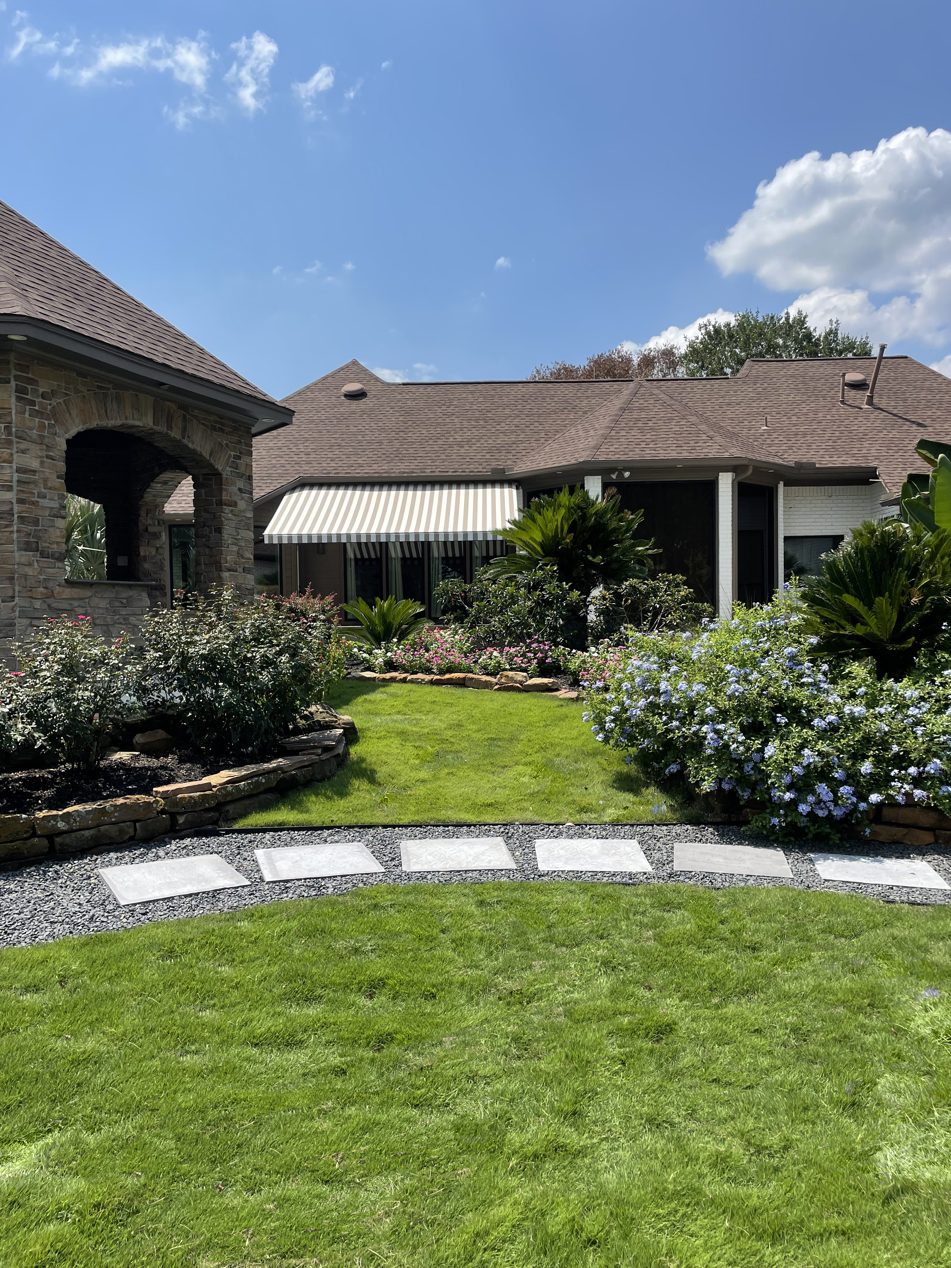 Landscaping in Tomball TX — stepping stones blackstar gravel pathway and planted beds — New Yards Landscaping