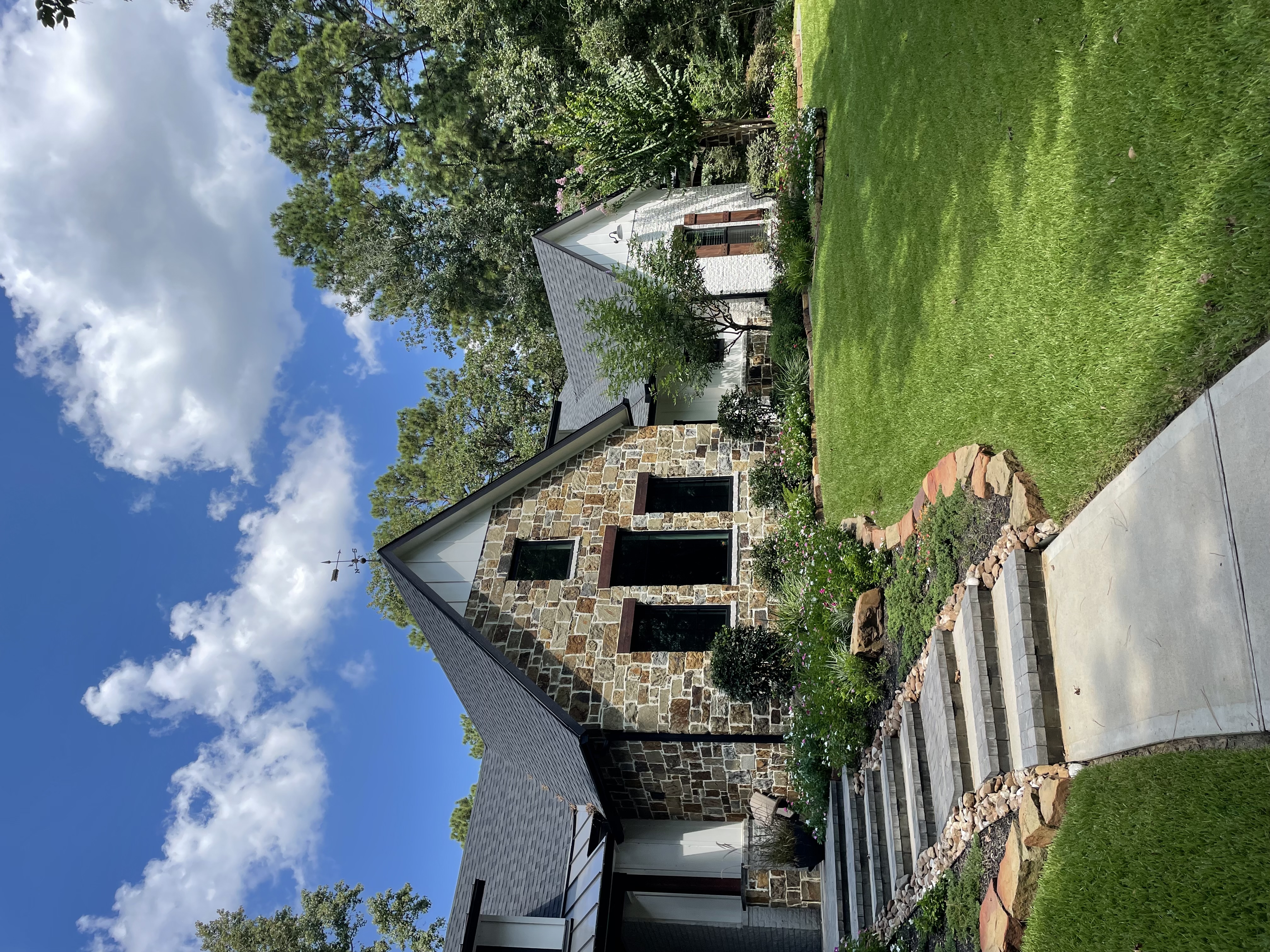 Wooded residential property with stone steps planted beds and mature trees The Woodlands TX — New Yards Landscaping