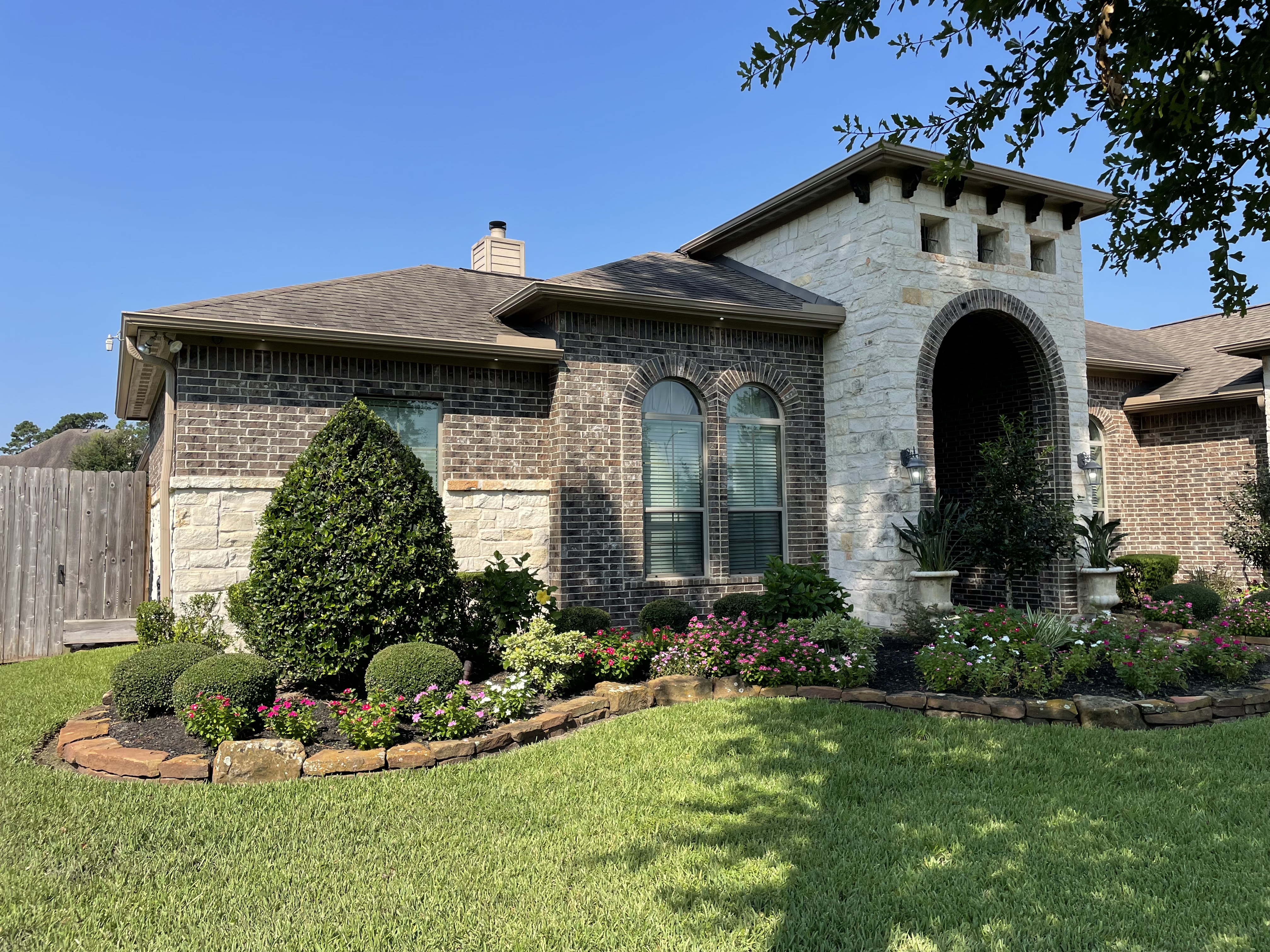 Front yard landscape with sculpted shrubs and seasonal beds — New Yards Landscaping
