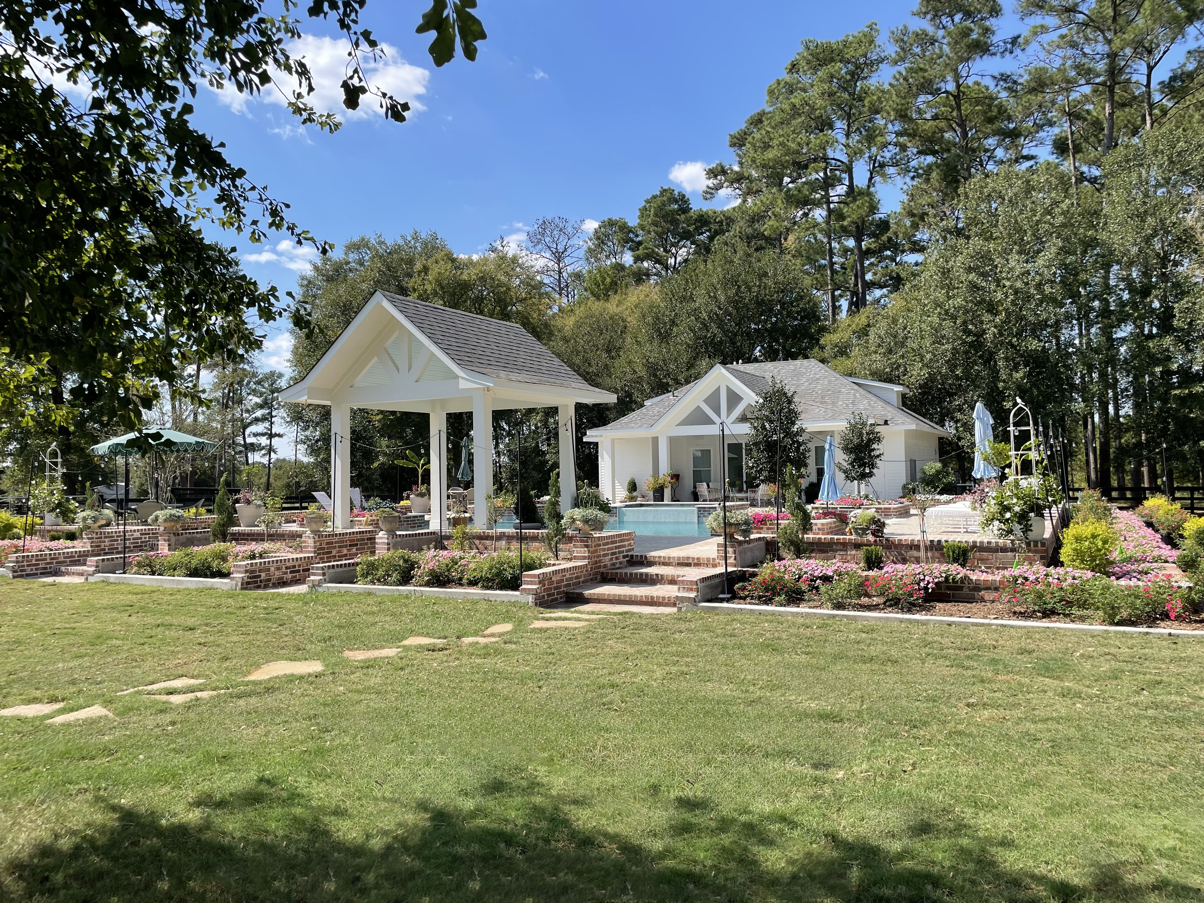 The Richards Estate — pool landscape with holly trees and seasonal color, Richards TX — New Yards Landscaping