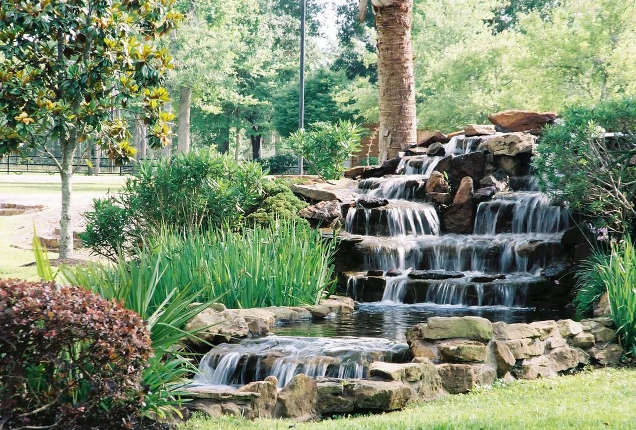 Castle Estate — multi-tier stone waterfall with lush plantings