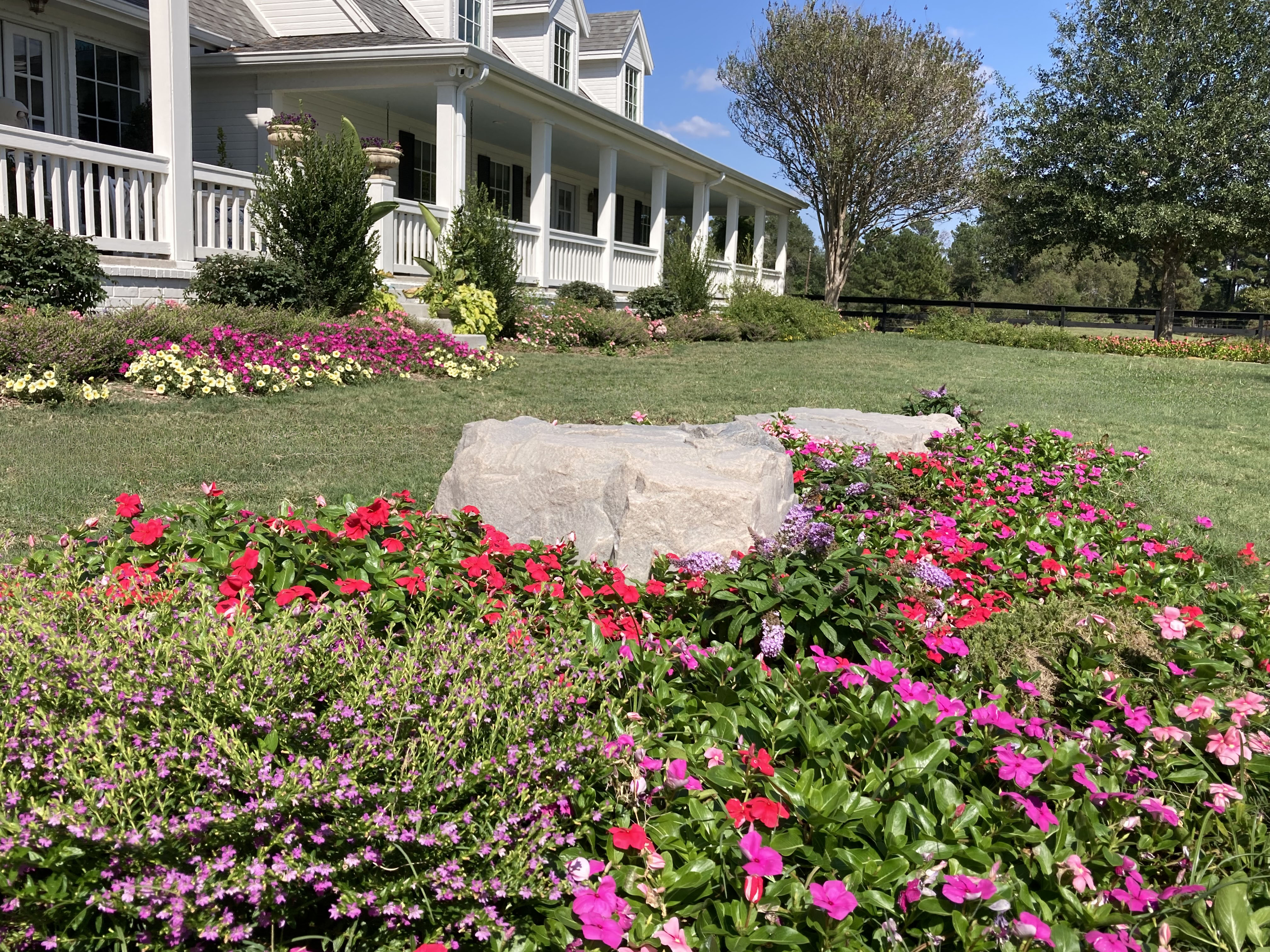 Richards Estate — close-up of front yard flower bed with boulders and seasonal color